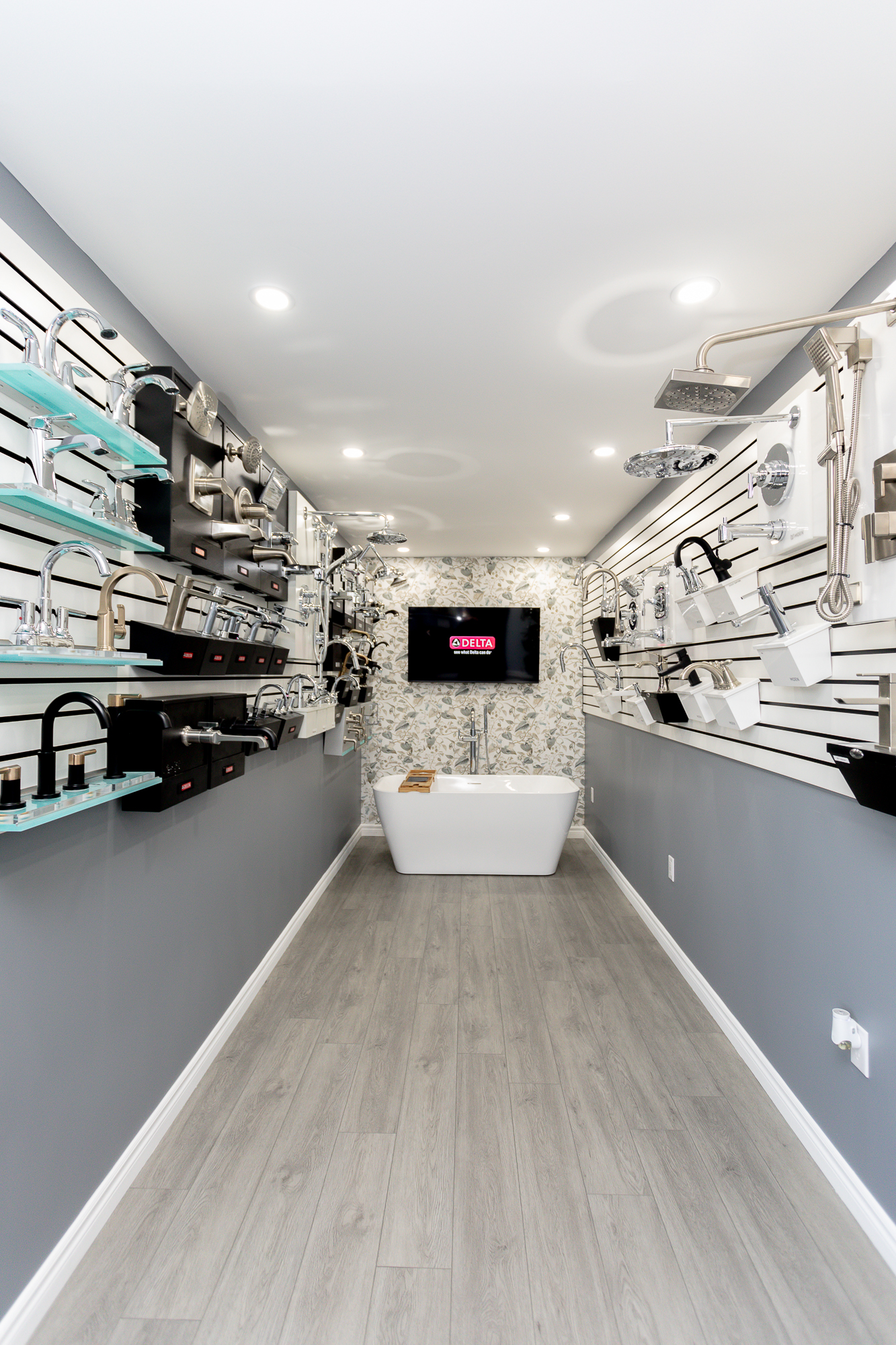 Elgin County Plumbing's Showroom with featured plumbing fixtures including bathtub, faucets and shower heads in St. Thomas Ontario.